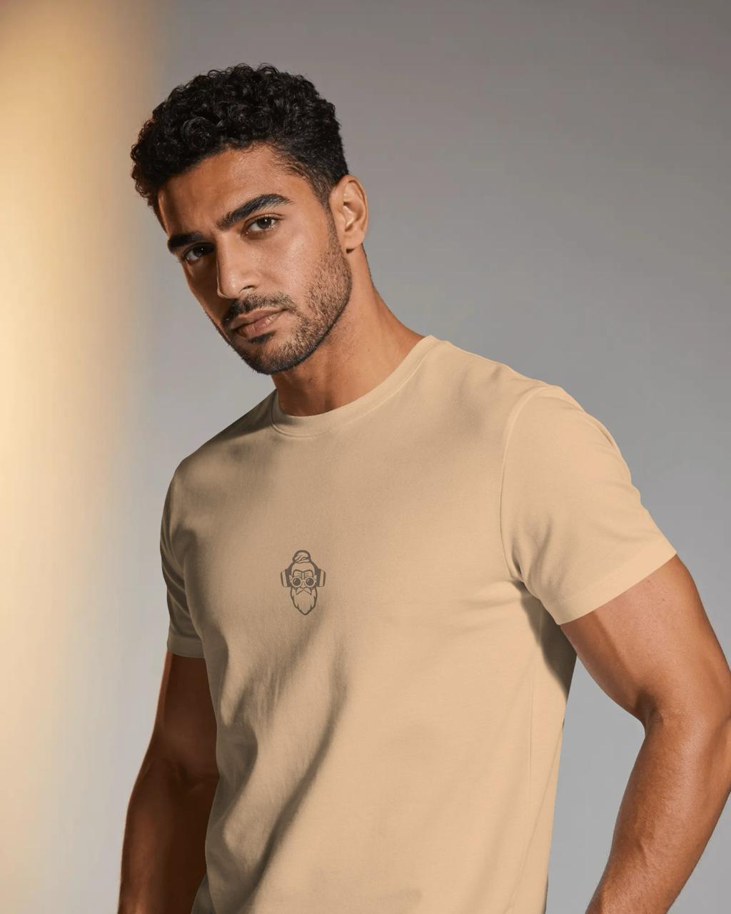 Indian man wearing clay tan Guru Daddy crew neck tee in warm golden light